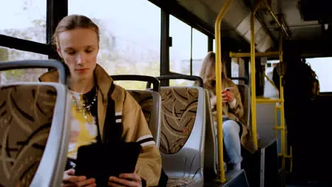 Young man using tablet in the bus