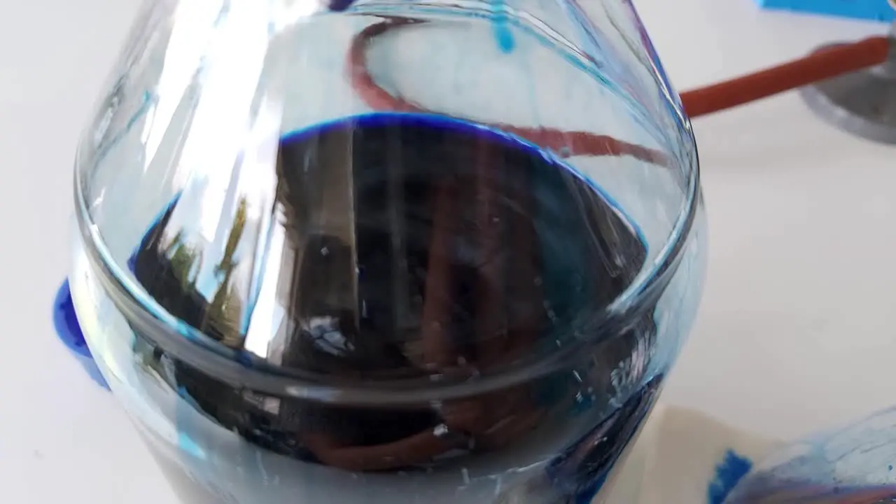 Close Up filtration of coomassie blue liquid solution in glass flask