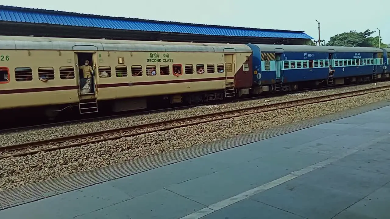 Indian Train running slowly through station