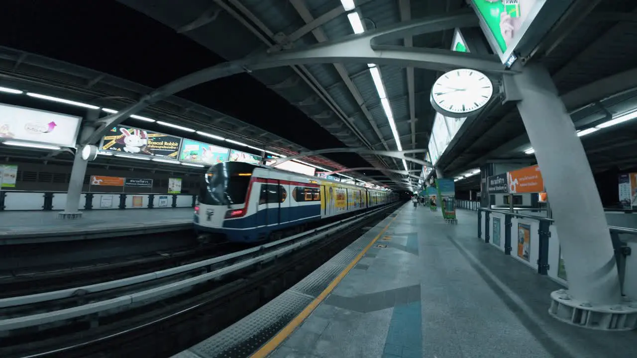 Following the moving metro on foot in a tunnel in Bangkok