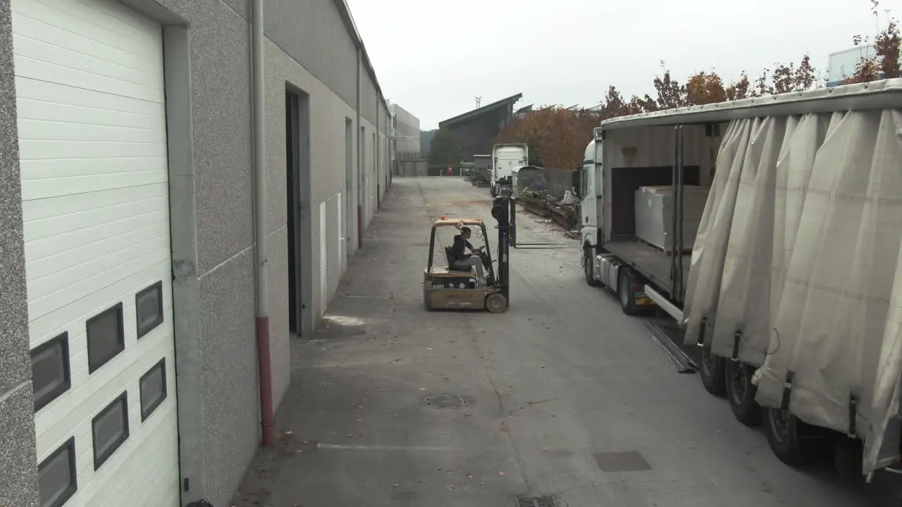 Forklift loading and unloading a truck in an industrial zone