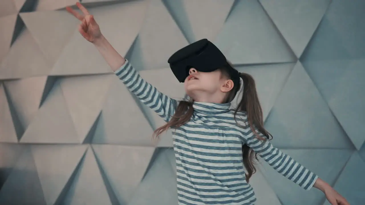 Little Girl With Virtual Reality Glasses Enjoying A Video Or Interactive Game