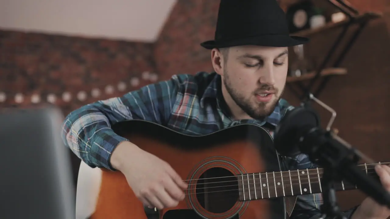 Young Male Musician Streaming A Video Tutorial Playing Guitar At Home 1