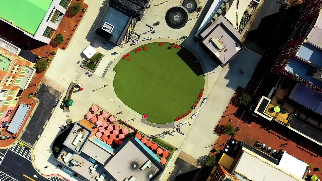 Aerial drone shot looking straight down and spinning slowly over the green turf and retail stores at Atlantic Station in Atlanta Georgia