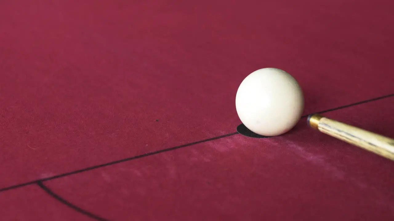 White ball being hit at the beginning of a pool game