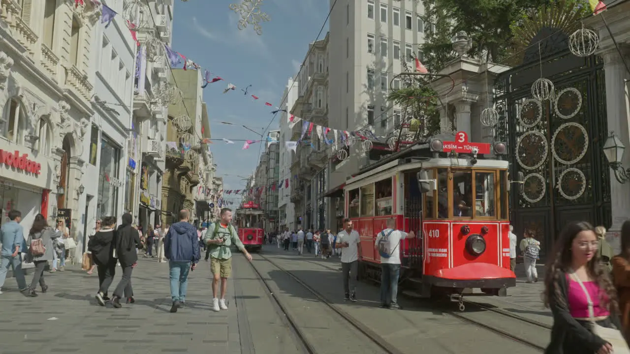 Istanbul city iconic electric red public trams meet on Istiklal street