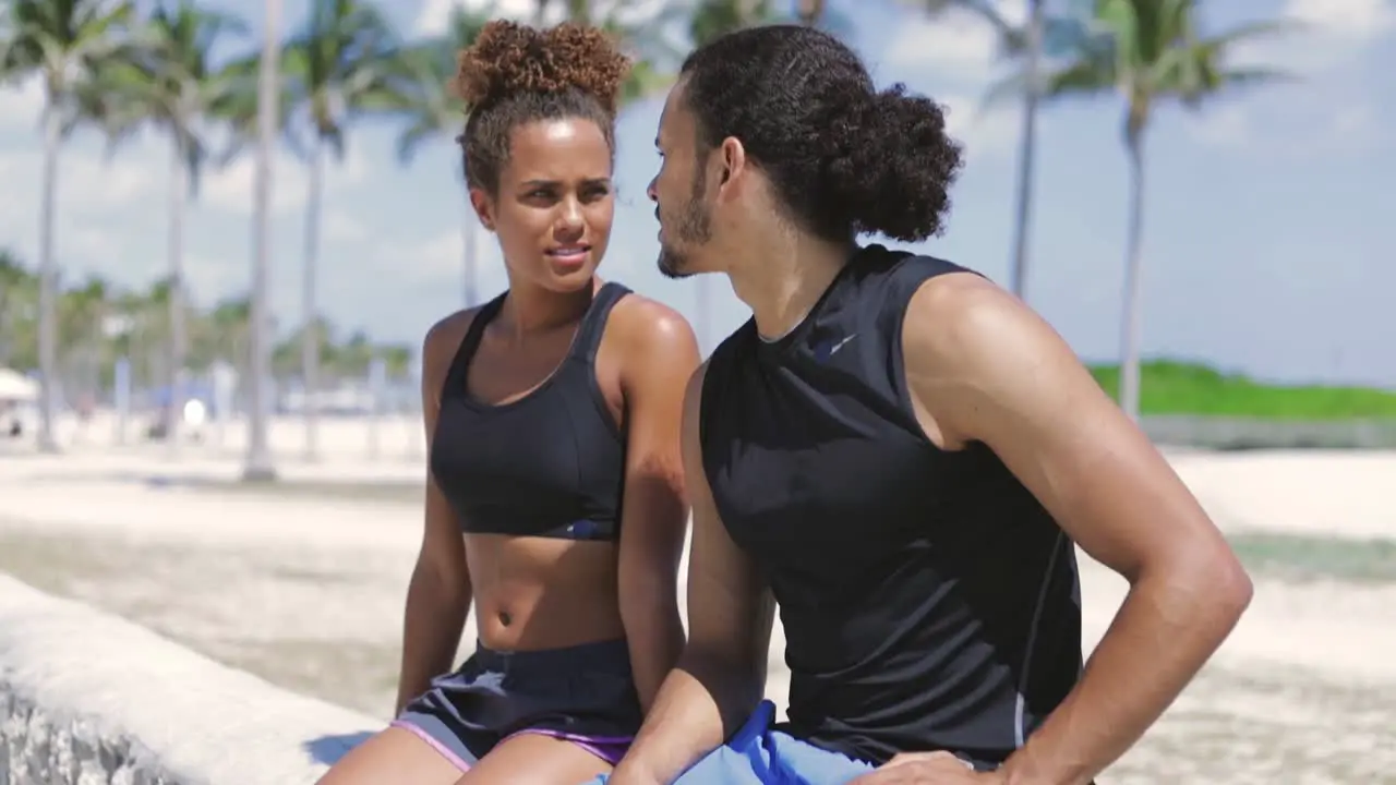 Athletic couple sitting and resting after sports