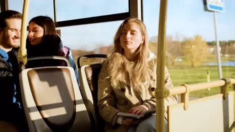 Young woman reading in the bus