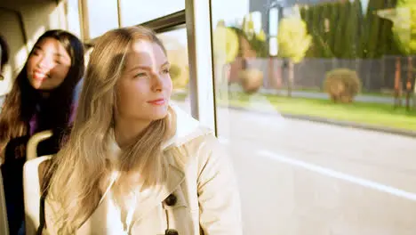 Young woman looking out the window in the bus