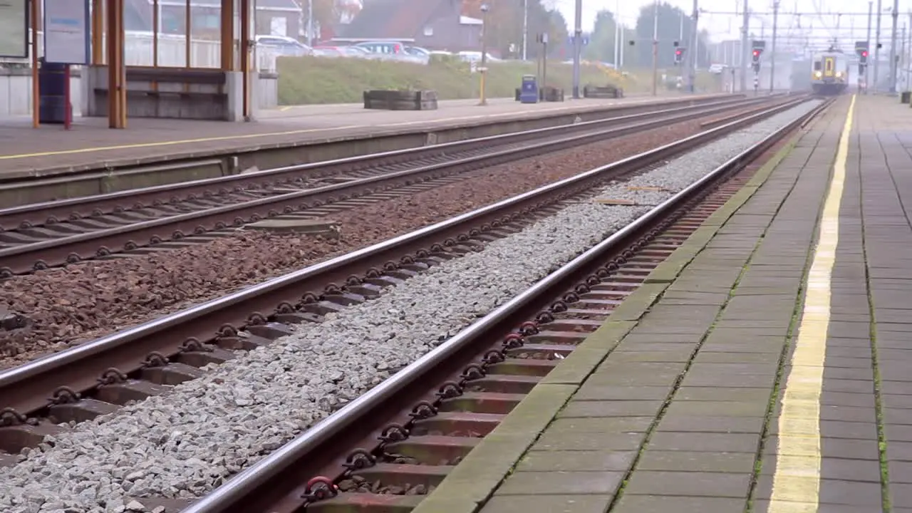 Train entering railway station and stops Doors open