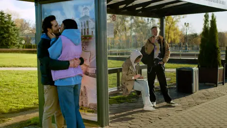 Couple kissing at bus stop