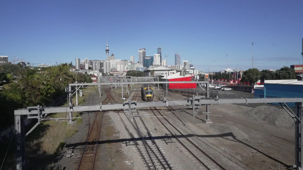 train coming towards the bridge from cbd auckland sky tower