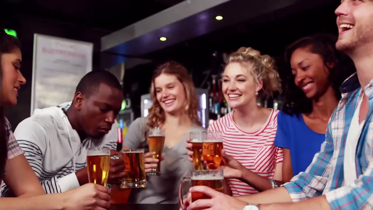 Animation of burning layer over happy group of friends drinking beer having fun at party