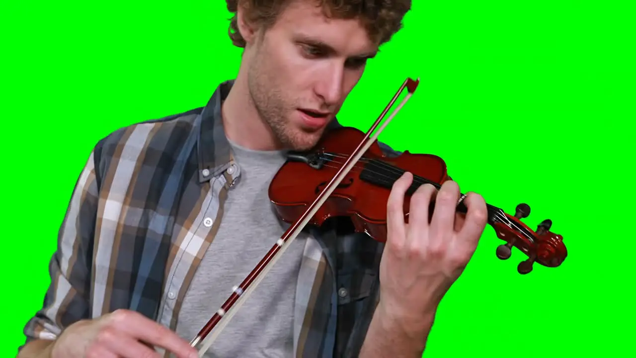 Close-up of male musician singing while playing violin