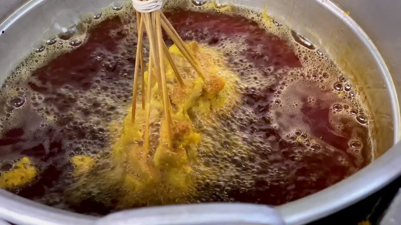 Food frying on the pan with brown oil