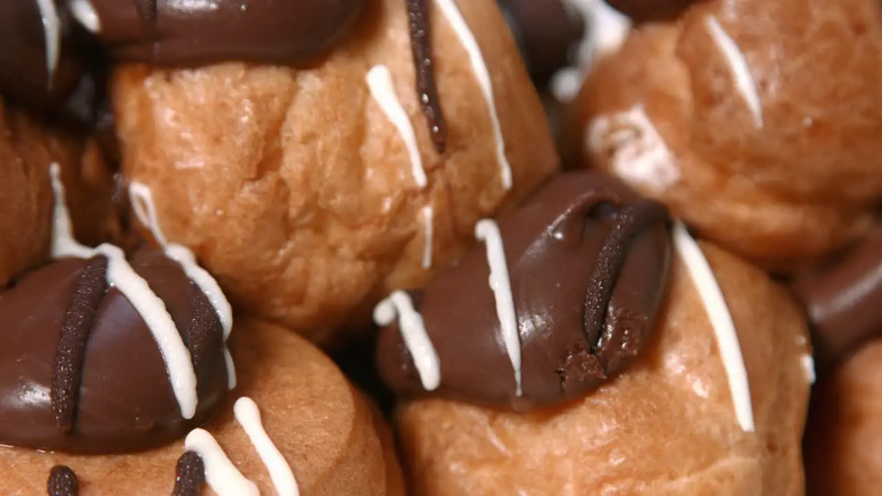 Close Up Pan of Close Up of Profiteroles Dessert with Chocolate Topping