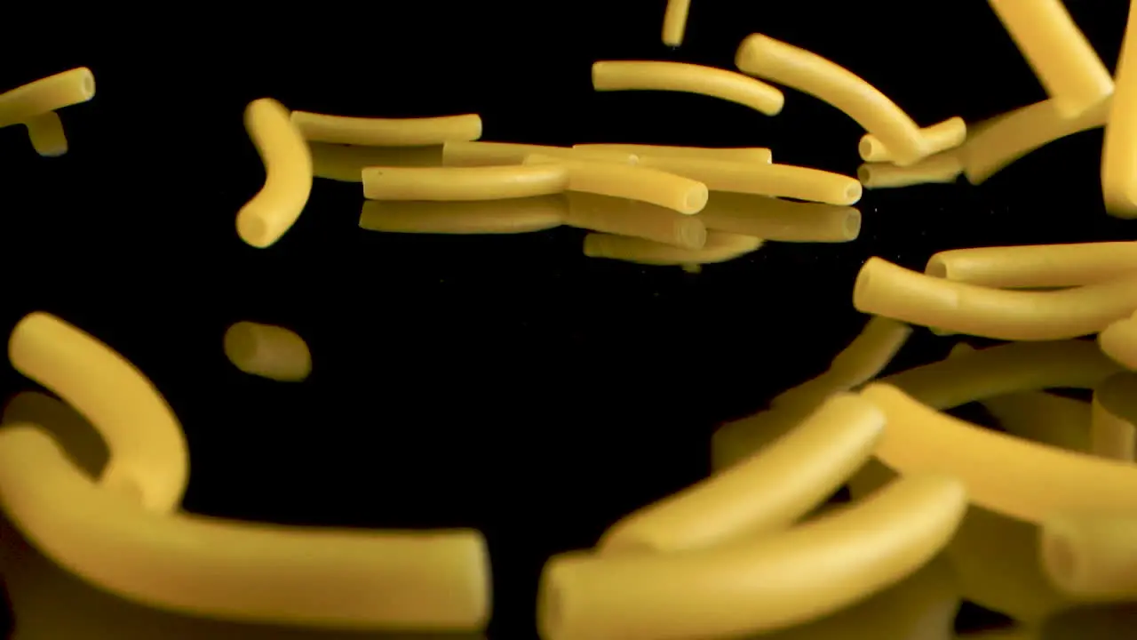 Slow Motion plus Macro Shot Of Falling macaroni on black background