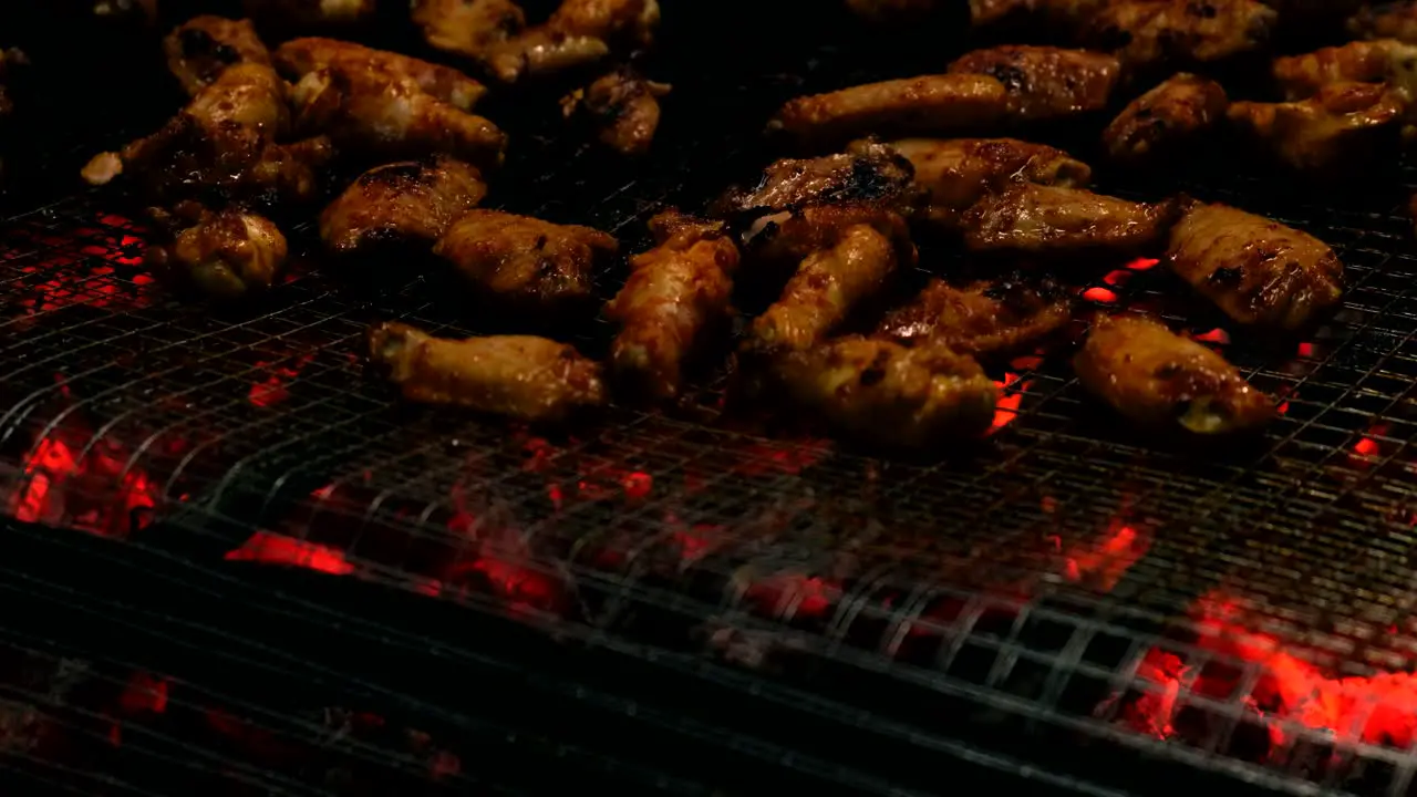 Closeup View of Delicious Spicy Grilled Chicken Wings on homemade BBQ Grill