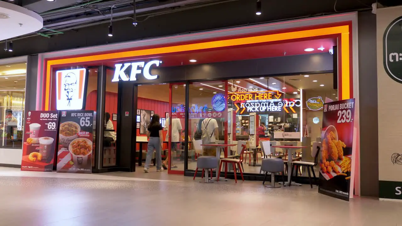 KFC Kentucky fried chicken fast food restaurant entrance in MBK center Bangkok shopping mall Thailand