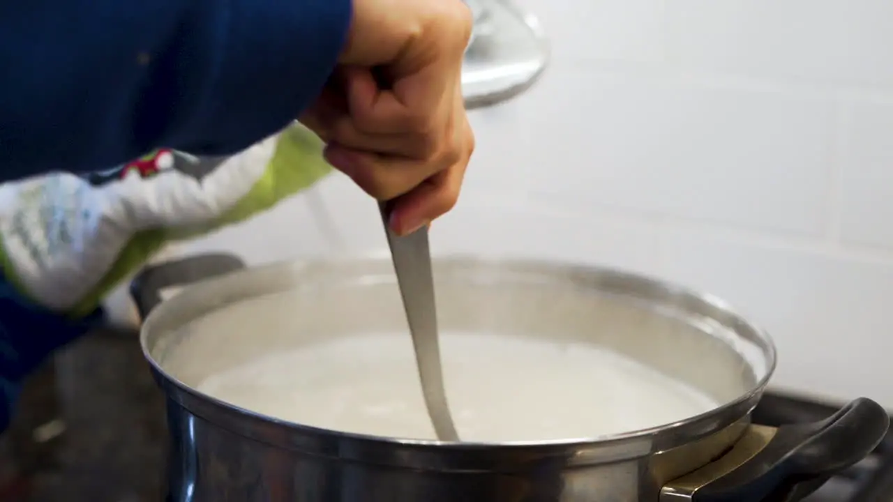 Mom stirring a pot of boiling water in slow motion