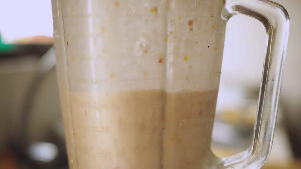 closeup of blender mixing ingredients to make leche de tigre