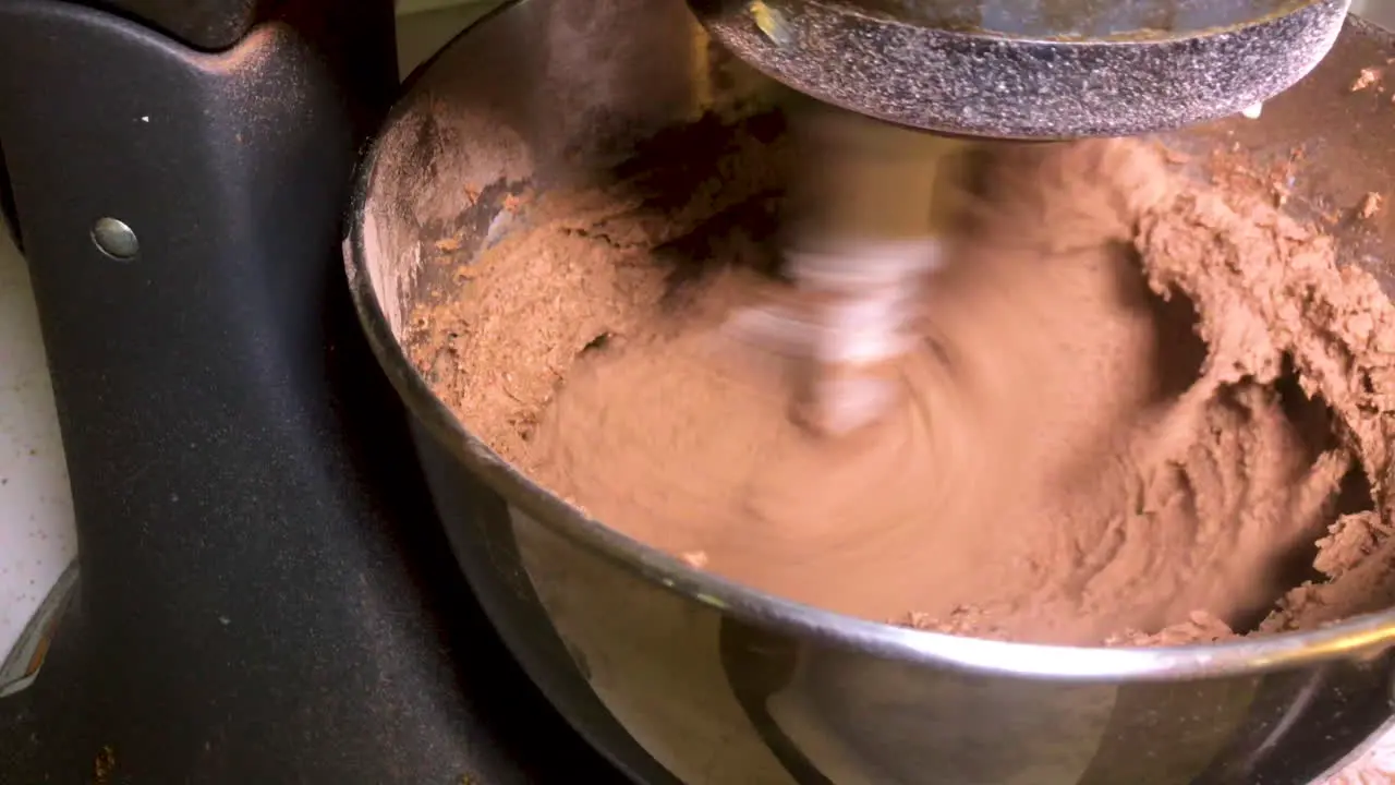 Kitchen mixer mixing chocolate frosting on fast speed