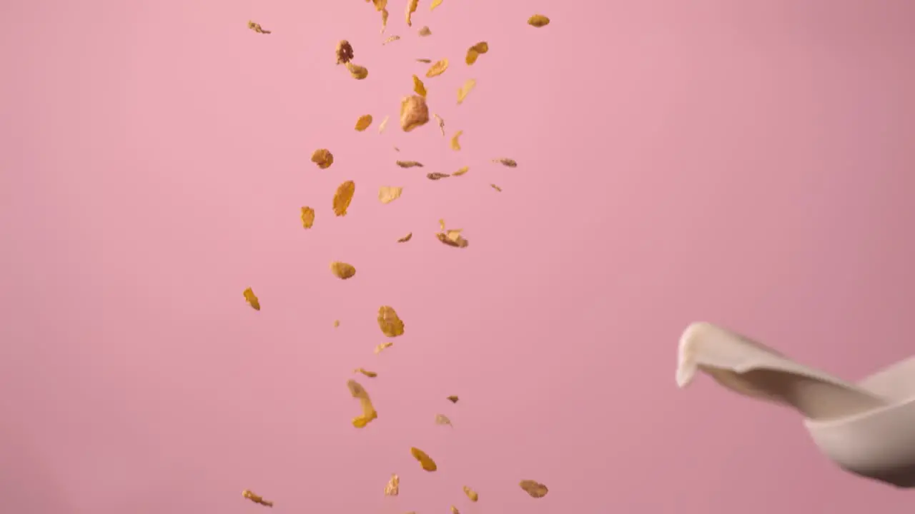 A White Person Tosses A Bowl Of Milk At Falling Pieces Of Cereal