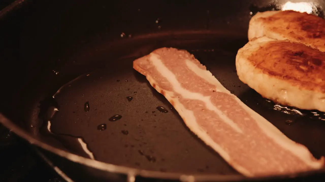 Vegan Bacon Being Put in Hot Pan Next to PlantBased Chicken Fillets