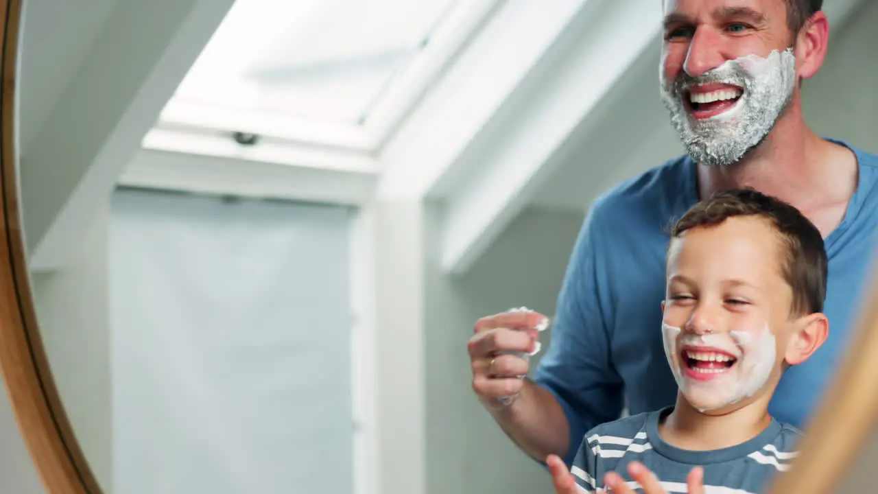 Dad child and shaving cream on face in bathroom