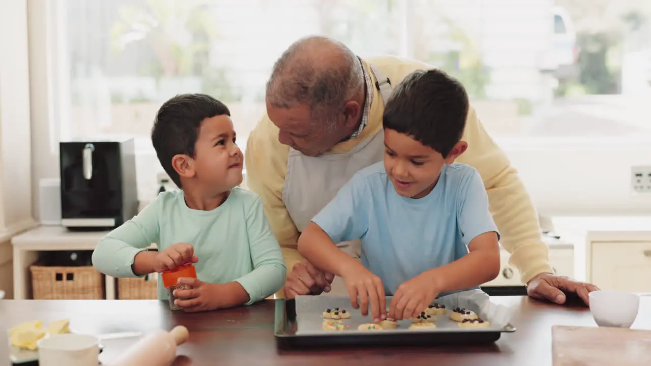 Grandfather talking or children baking in kitchen