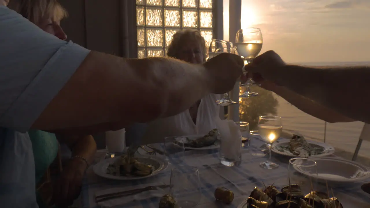 People toasting during dinner on the balcony