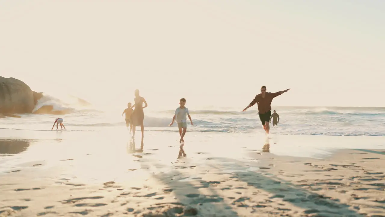 Beach happy family parents and children running