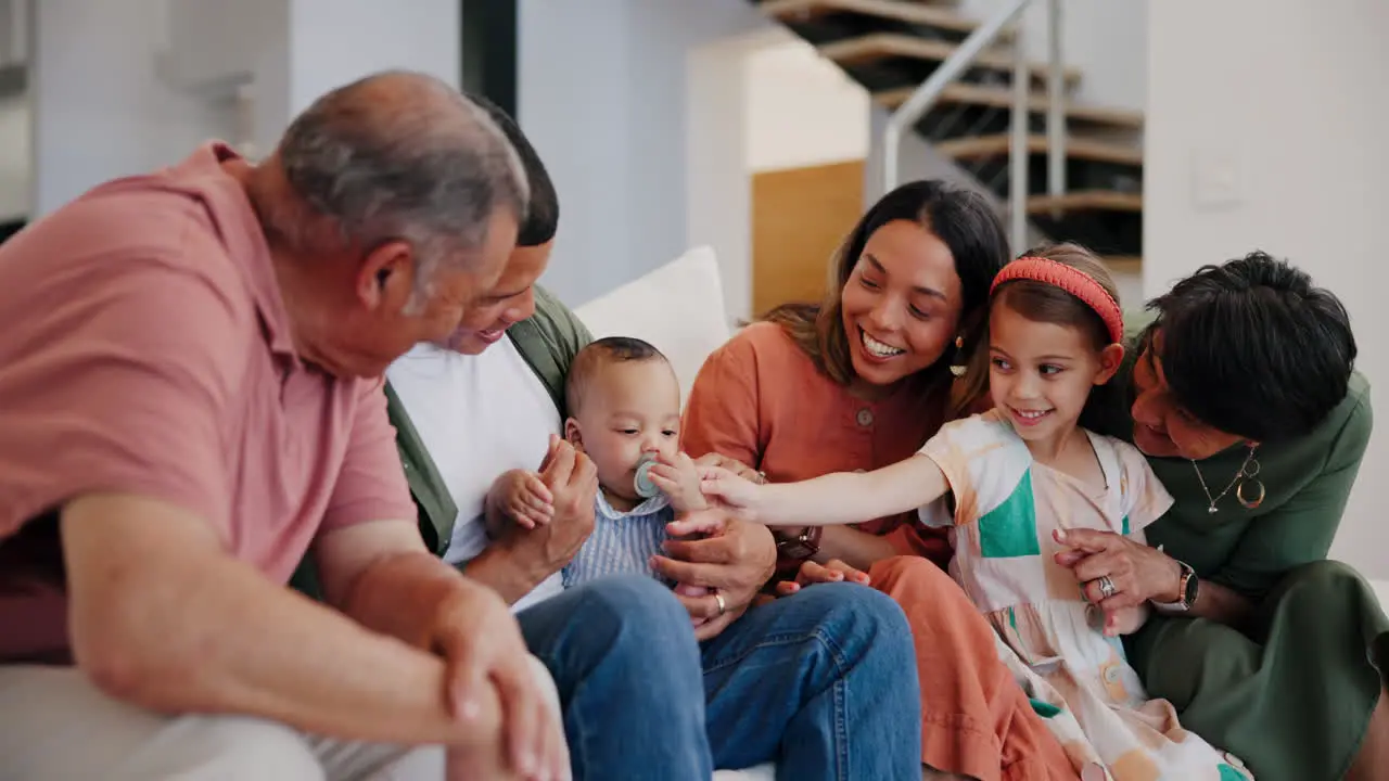 Big family baby and parents play on sofa in home