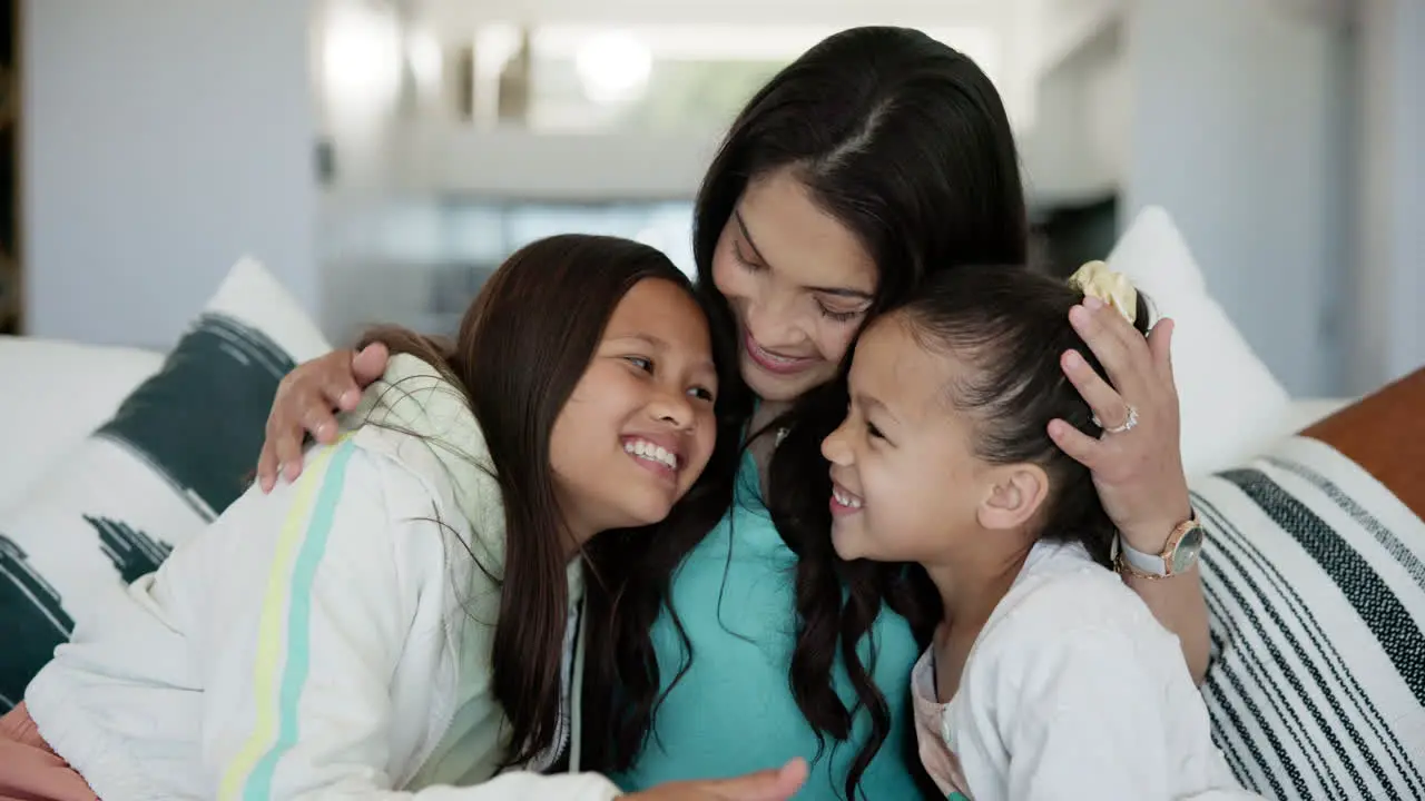 Love hug and mother with girl children on a sofa