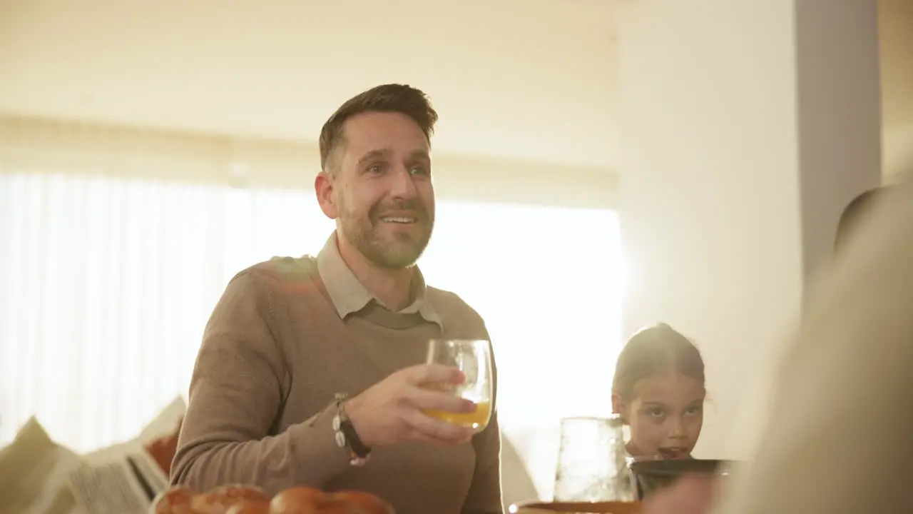 Glass toast and a man at a family gathering