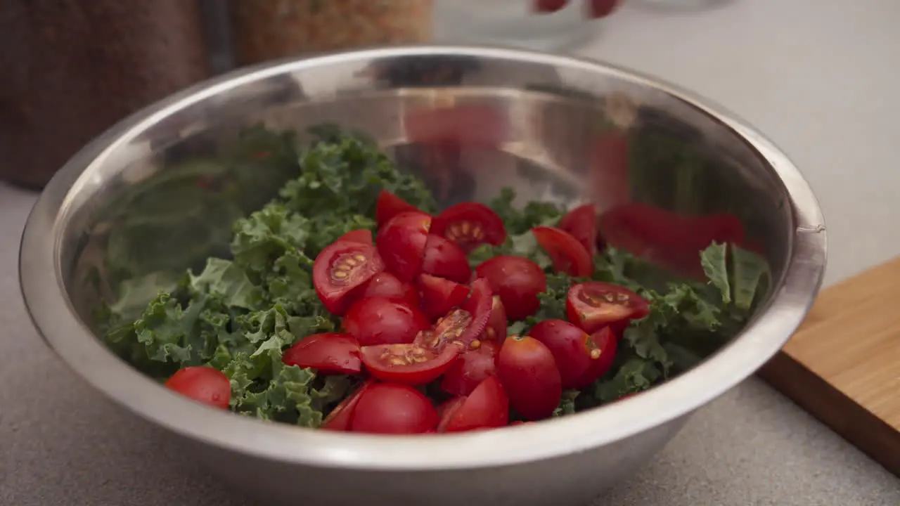 Putting tomatoes into a salad bowl
Vegetarian salad cooking