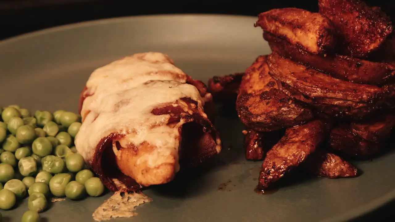 PlantBased Chicken Fillet Wrapped in Vegan Bacon with Paprika Rustic Potato Wedges and Peas