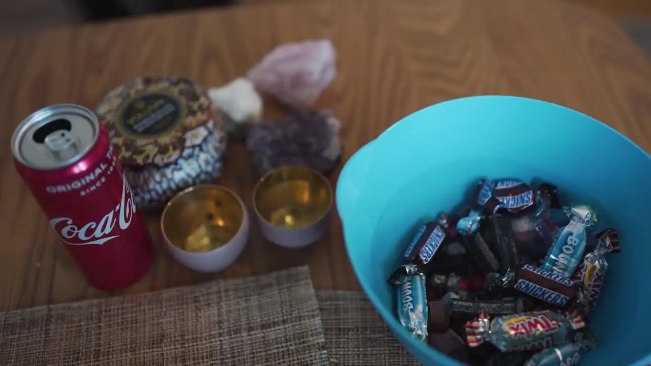 Panning view going from a bowl filled with candy over to a coke