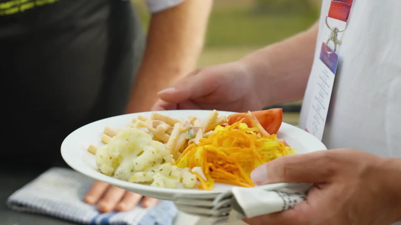 Close Up Of Man Grilling Sauage And Meat Serving Food On Plate