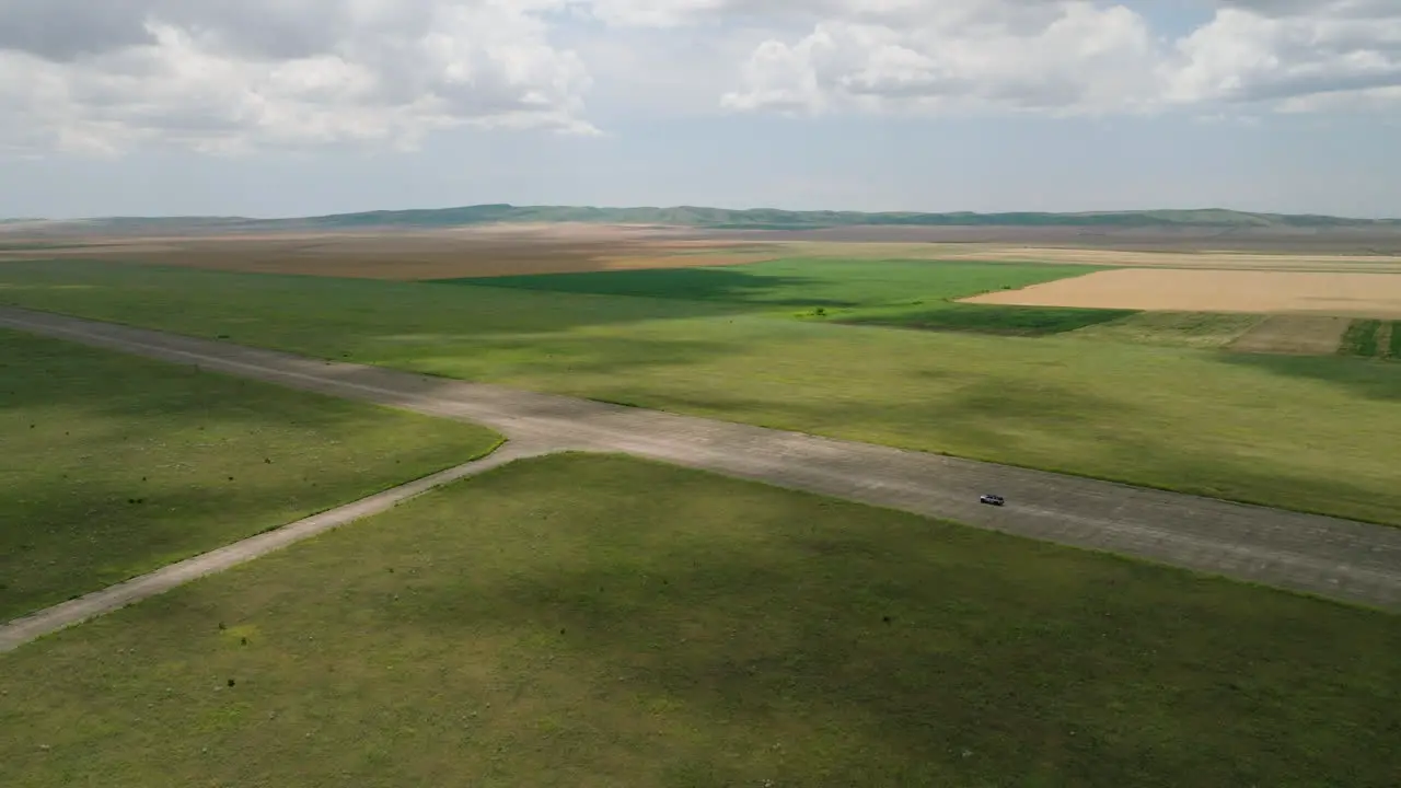 Car driving on runway of abandoned Shiraki military airfield Georgia