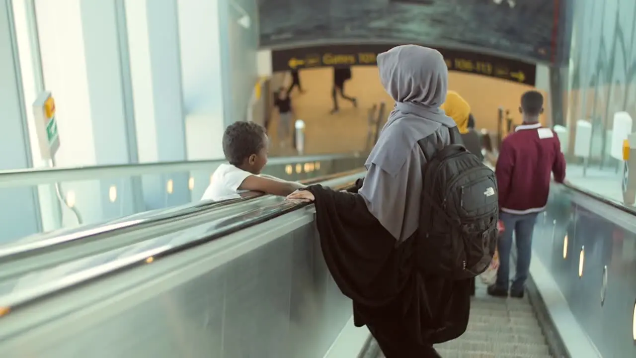 Mother and Son Travelling Through an Airport