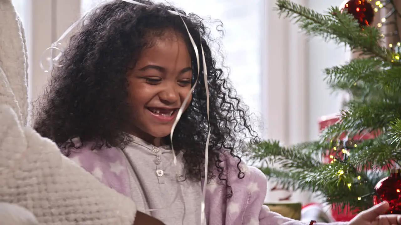 Child Playing With Ribbons at Christmas