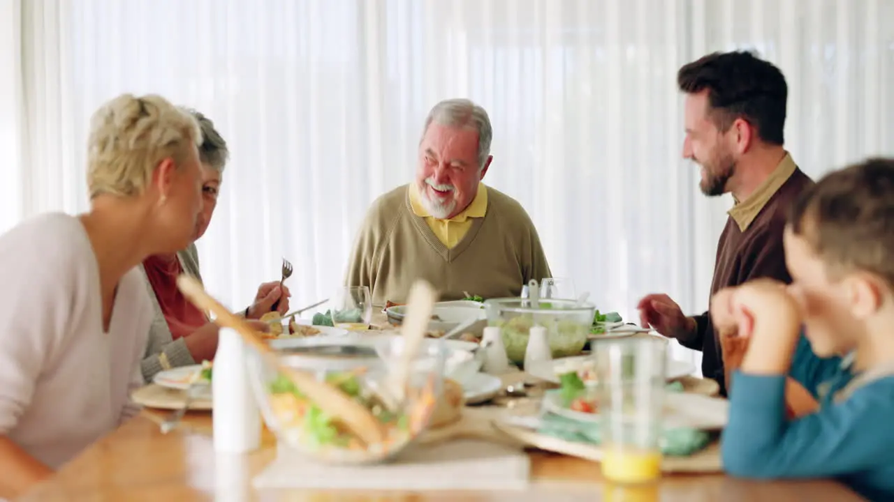 Happy family lunch and laughing at a dining table