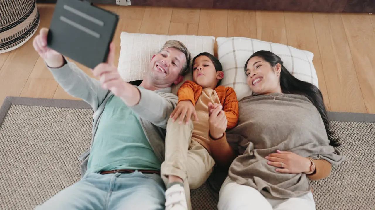 Happy family tablet and lying on floor