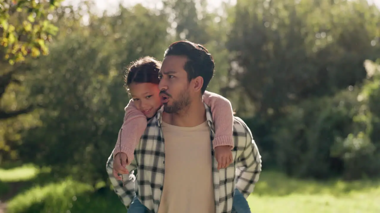 Father child and back ride in nature for walking