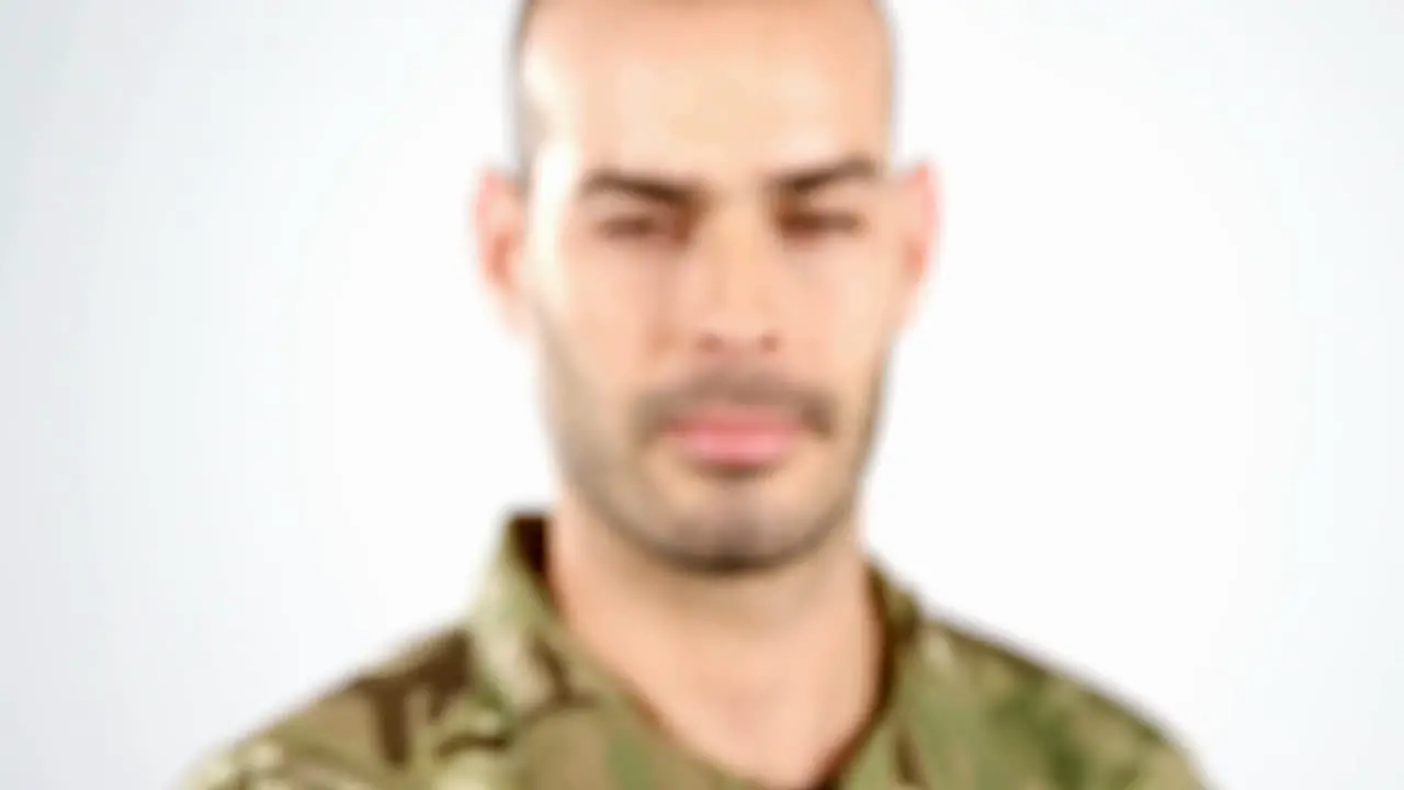 Soldier holding house model on white background