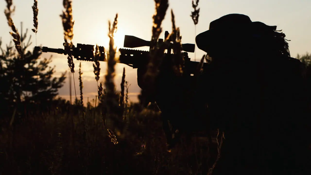 A solider aims his rifle 7