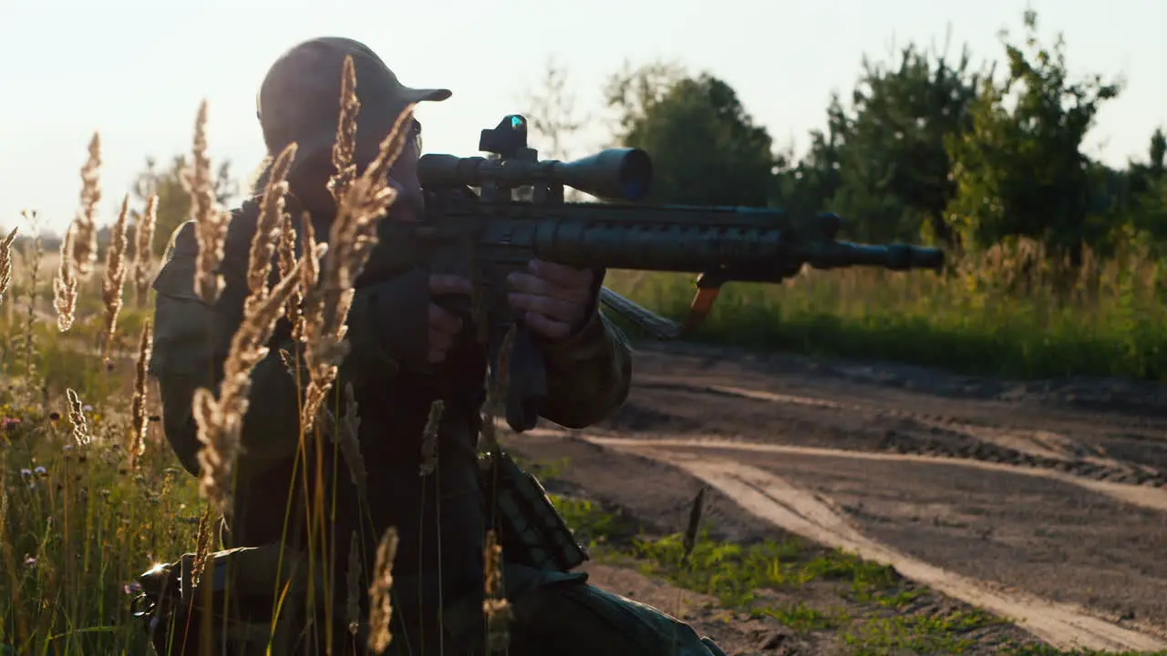 A solider aims his rifle 2