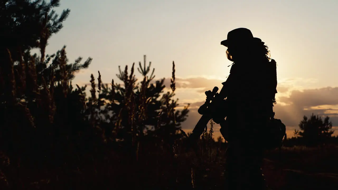 A solider aims his rifle 8