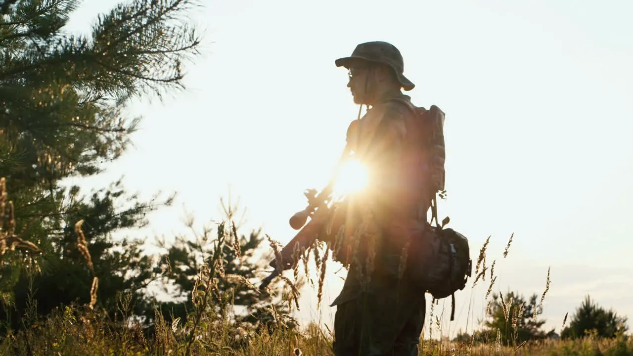 A solider aims his rifle 4